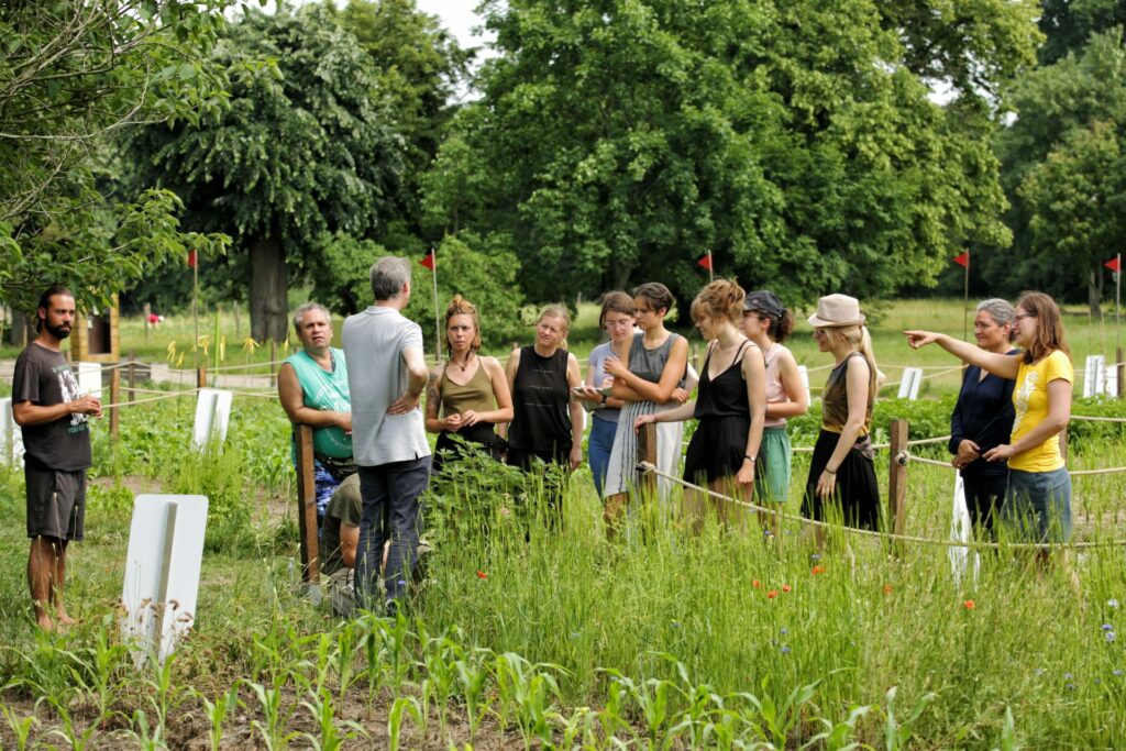 A group of young adults listens eagerly to a field trip