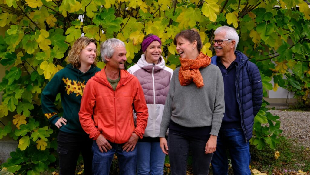 Five members of the Bern Global Field team laugh at each other.