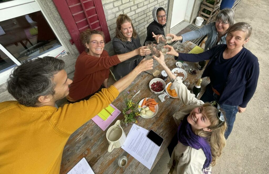 The founding members of Weltacker Zurich raise their glasses in a celebratory toast. 