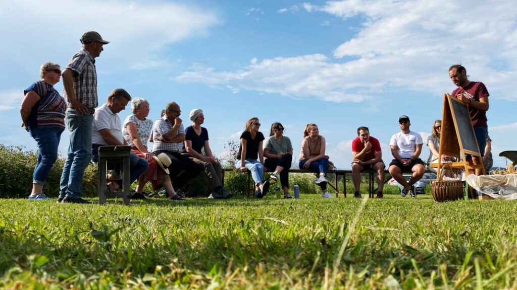 A group of adults listen intently to the educational speaker from the Weltacker St. Michael team.